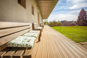 a row of benches sitting on a porch at Apartmány Dalov in Šternberk +37 photos