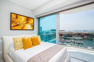 a bedroom with a large window and a bed with yellow pillows at Nautico nautico 8a in Puerto Vallarta +19 photos