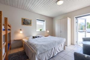 a bedroom with a bed and a window at Fantastic Holiday Property Kragelund For Up To 24 Guests! in Åbybro