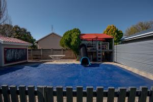 a backyard with a basketball hoop and a playground at Die Moerbeiboom in Bloemfontein