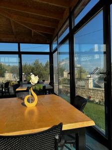 a dining room with a table with a vase on it at SEA & LAKE VIEW VILLA in (( Kalive Gjoka ))