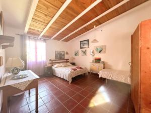 a room with two beds and a table in it at Casa Olivia Sant Lluis in Sant Lluis