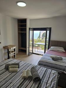 two beds in a bedroom with a view of the ocean at Villa Aequum in Trogir