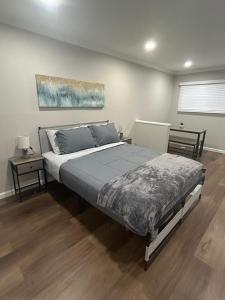 a bedroom with a large bed and two tables at The Comfort Cove in Cleveland