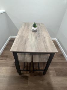a wooden table with a potted plant on top of it at The Comfort Cove in Cleveland