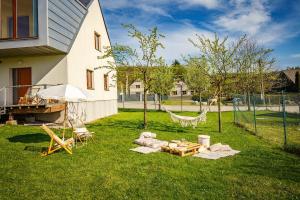 a hammock in a yard next to a house at Apartmány Dalov in Šternberk