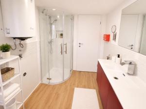 a white bathroom with a shower and a sink at Villa Rosa dei Venti in Kaštel +17 photos