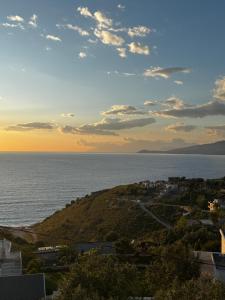 a view of the ocean from a building at SEA & LAKE VIEW VILLA in (( Kalive Gjoka ))