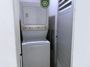 a small white washer and dryer in a bathroom at Ocean view 2BR Condo - Private Terrace - Beach in Nuevo Vallarta
