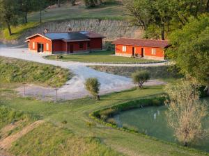 two buildings on a hill next to a river at B&B La Tana in Belforte del Chienti +12 photos