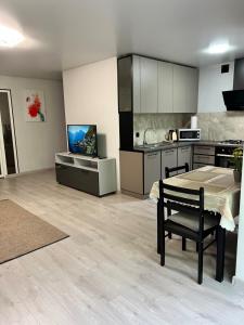 a kitchen with a table and a dining room at Komarova in Chernivtsi