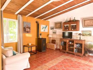 a living room with a couch and a tv at Casa Olivia Sant Lluis in Sant Lluis