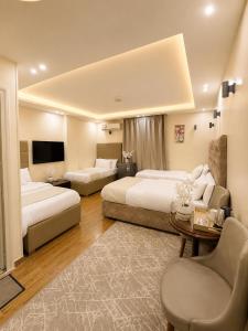 a large hotel room with two beds and a couch at Hadayek Al-Ahram Guest House - حدائق الاهرام جيست هاوس in Giza