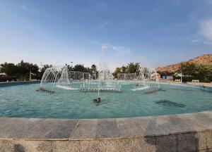 a fountain in a pool of water at ADEL Privet Hostleإيواء خاص in Taif