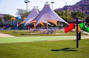 a park with a playground with colorful play structures at ADEL Privet Hostleإيواء خاص in Taif