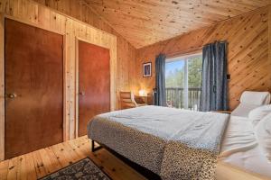 a bedroom with a bed in a wooden room at Rustic Waterfront Kayak Near National Park in Tobermory