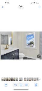 a bathroom with a sink and a toilet and a window at The Signature Stay in Clifton