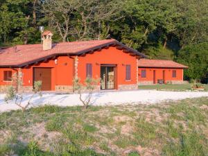 an orange house with a red roof at B&B La Tana in Belforte del Chienti
