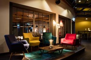 a room with colorful chairs and a table with a candle at Ruby Marie Hotel Vienna by IHG in Vienna
