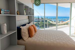 a bedroom with a bed with a view of the ocean at Ocean view 2BR Condo - Private Terrace - Beach in Nuevo Vallarta +28 photos