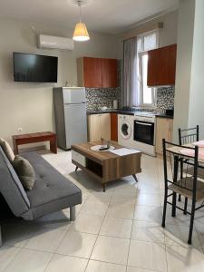 a living room with a couch and a table at Sissy Home -Central Studio in Vathi in Samos
