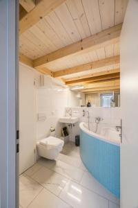 a bathroom with a tub and a toilet and a sink at Apartment in Sankt Moritz in St. Moritz +37 photos