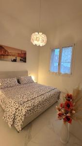 a bedroom with a bed and a chandelier at Angels Venice in Marghera