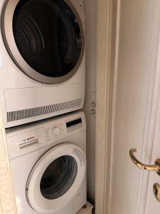 a microwave and a washing machine in a room at Apartment in Sankt Moritz in St. Moritz