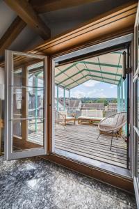 a balcony with sliding glass doors and a chair at Apartment in Sankt Moritz in St. Moritz