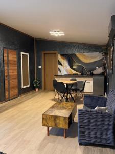 a living room with a table and chairs at Diamona apartment lux sa pogledom na bazen in Donja Toponica