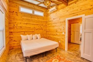 a bedroom with a bed in a wooden wall at Lagoon Ranch RV Resort in Onalaska +24 photos