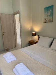 a bedroom with a bed with two towels on it at Sissy Home -Central Studio in Vathi in Samos