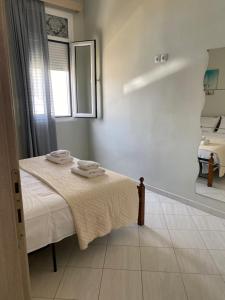 a bedroom with a bed with towels on it at Sissy Home -Central Studio in Vathi in Samos