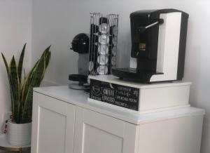 a table with a coffee maker on top of a book at Komodo Rooms in Agropoli