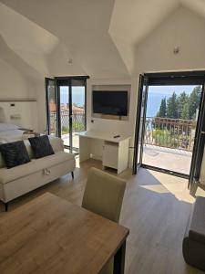 a large living room with a couch and a tv at Villa Aequum in Trogir