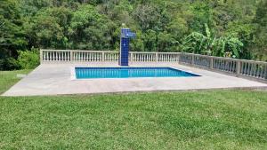 a swimming pool in the middle of a yard at Chácara Pousada in Juquitiba