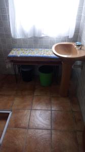 a bathroom with a table and a small sink at Chácara Pousada in Juquitiba