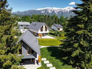 an aerial view of a house with mountains in the background at Ambient Resort Bled in Bled