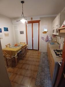 a kitchen with a table and a dining room at Attico 26 in Salcedo