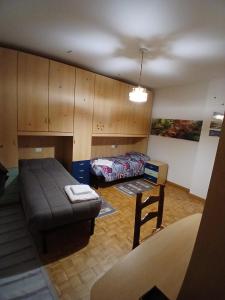 a living room with a couch and a bed at Attico 26 in Salcedo +4 photos
