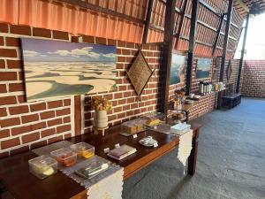 a room with a table in a brick wall at Pousada Solar Maia Costa in Atins +33 photos