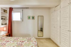 a bedroom with a bed and a mirror at Art- Apartamentos Revilla Tacke E in Empuriabrava +20 photos