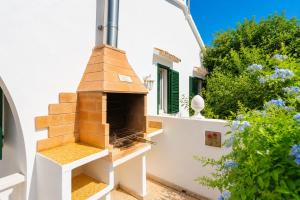 a bird house on the side of a house at Villa Emilio in Cala en Porter