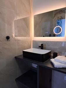 a bathroom with a black sink and a mirror at 104 - centre de voiron - DeTassigny in Voiron