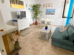 a living room with a blue couch and a table at La Casina di Perla in Viareggio
