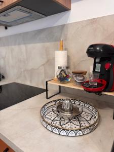 a kitchen counter with a plate on a table at 104 - centre de voiron - DeTassigny in Voiron +2 photos