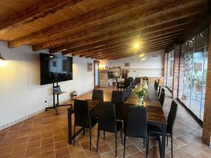 a dining room with a large table and chairs at Casale Sol Armonie in Codroipo