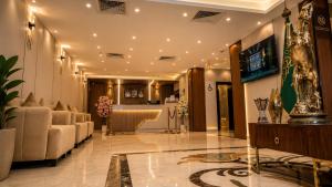 a lobby with couches and a bar in a building at دار السناء للشقق المخدومة Dar Al Sanaa Serviced Apartments in Jeddah