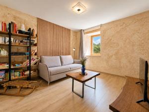 a living room with a couch and a table at Voyage éco-responsable Immersion nature Wifi in Belleydoux