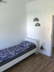 a small bedroom with a bed and a table at Arnold Apartments 2 in Glauchau +10 photos